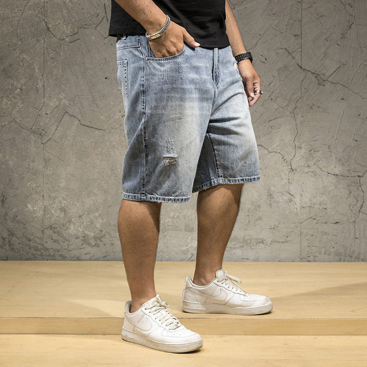 Light wash distressed denim shorts for men, featuring stylish rips, great for a modern street style look.
