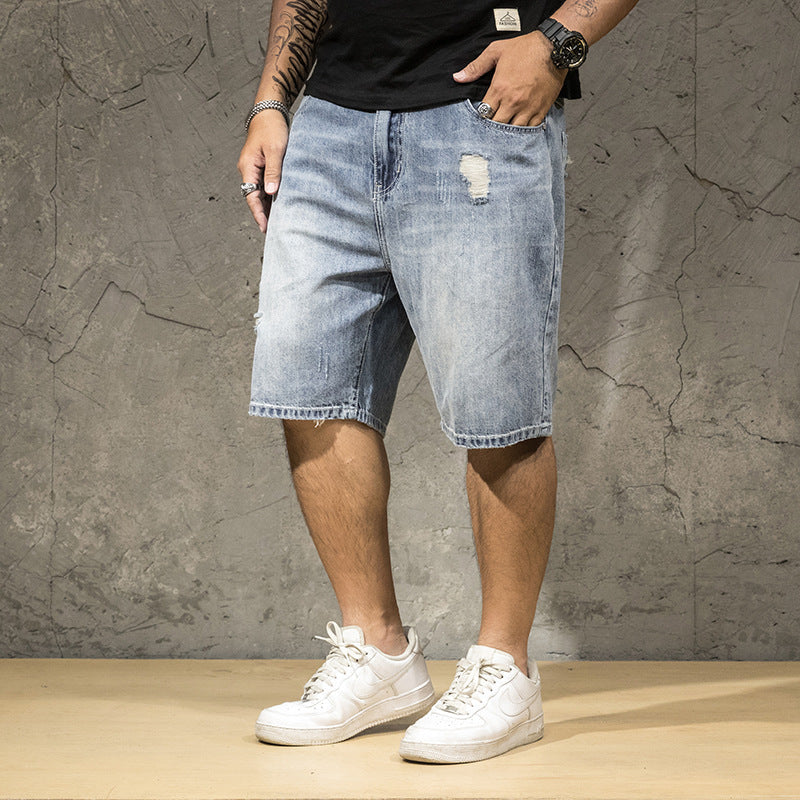 Trendy men's light wash ripped shorts with distressed details, versatile for summer casual and street fashion.