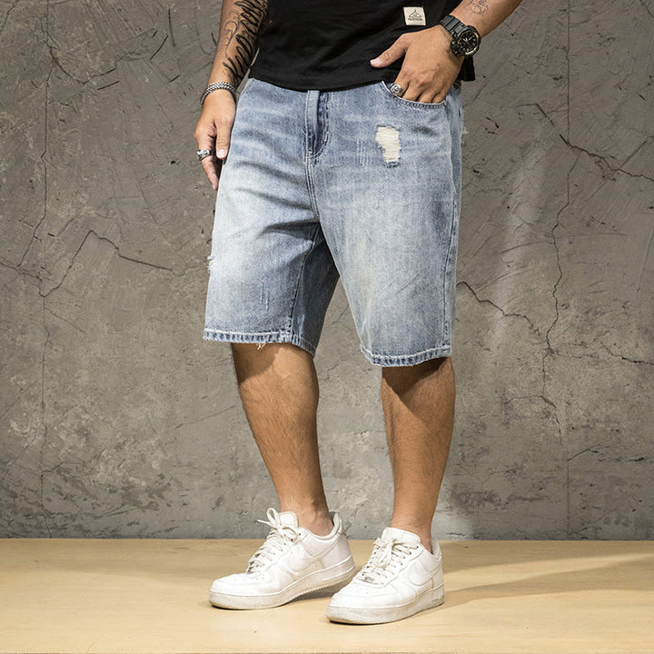 Trendy men's light wash ripped shorts with distressed details, versatile for summer casual and street fashion.