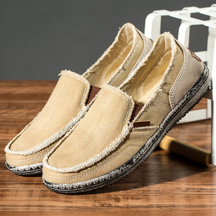 Modern men's distressed slip-on loafers with a round toe, perfect for effortless casual fashion.