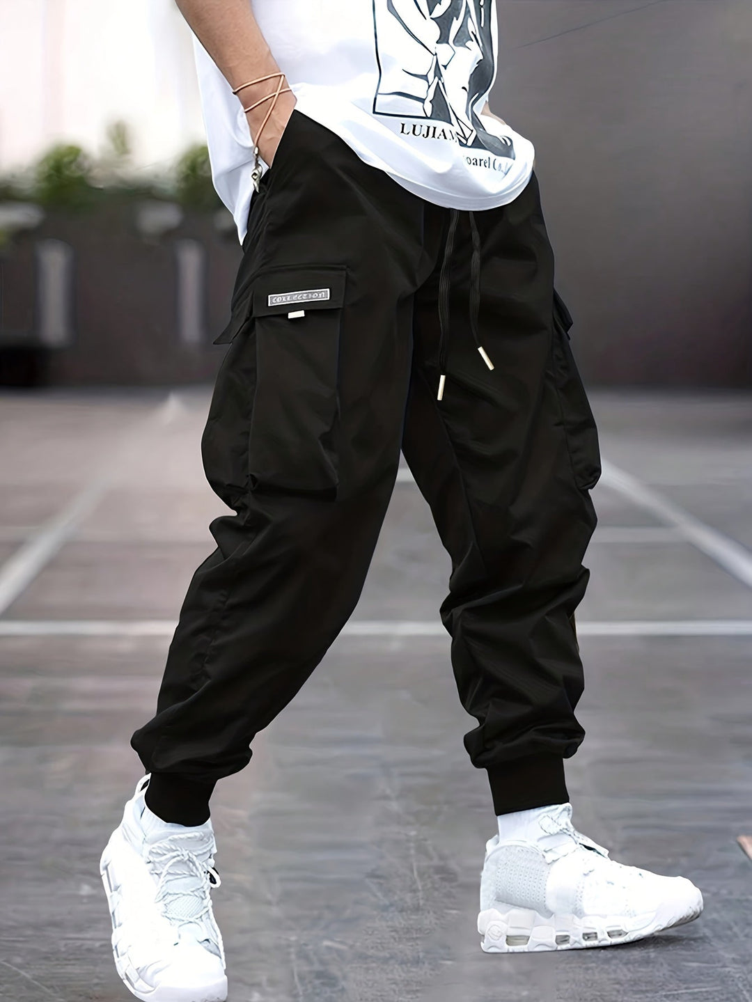 Men's drawstring cargo pants, comfortable & stylish, with multiple utility pockets & elastic ankle cuffs.