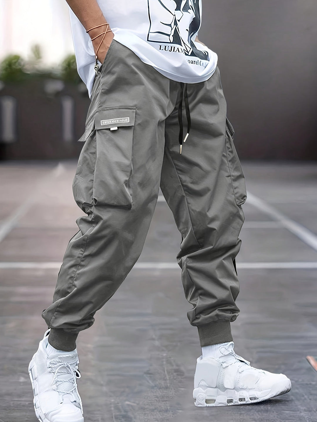 Utility cargo pants for men, featuring an adjustable drawstring waist and practical multi-pockets, perfect for streetwear.