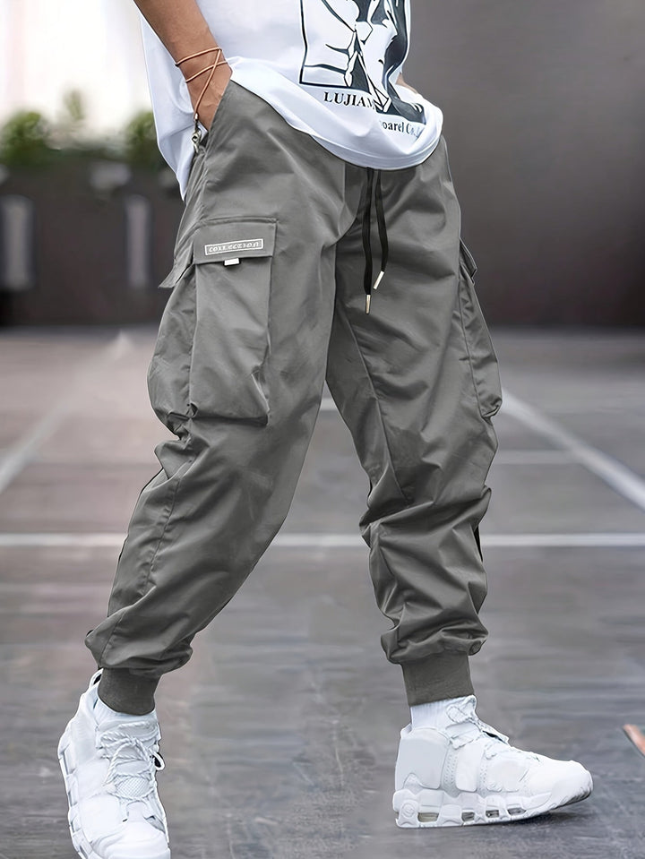 Utility cargo pants for men, featuring an adjustable drawstring waist and practical multi-pockets, perfect for streetwear.