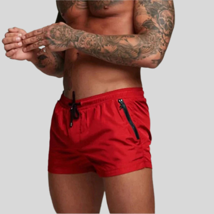 Men's casual swim shorts with drawstring waist & practical zip pocket detail. Great for swimwear.