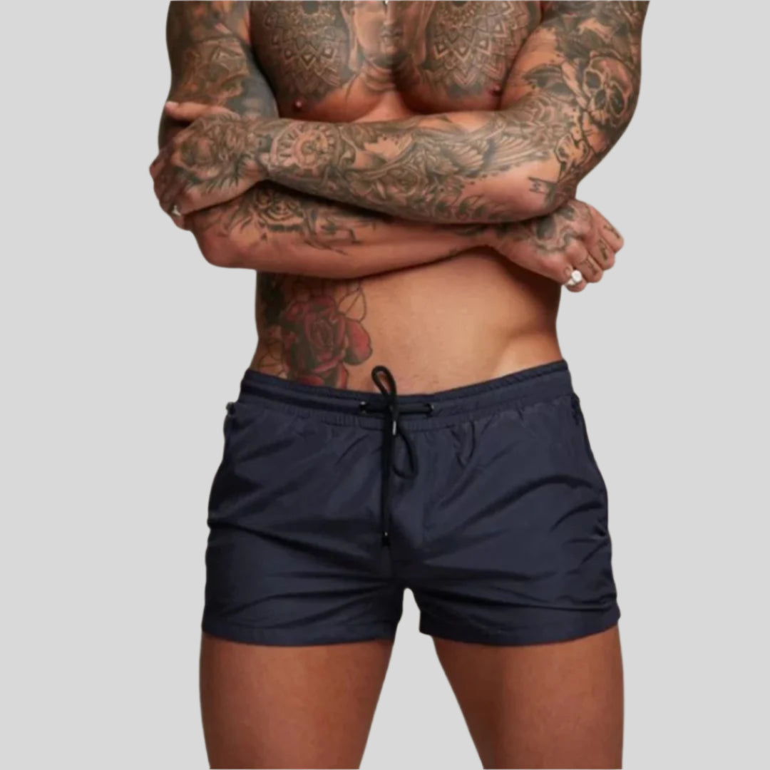 Men's stylish swim shorts with drawstring & zip pocket, paired with a tee for casual summer fashion.