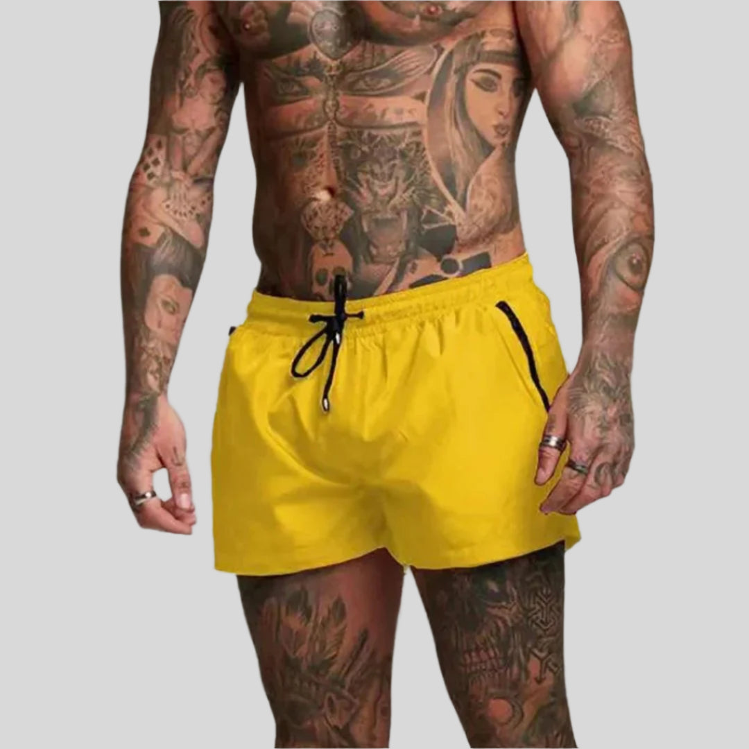 Versatile men's drawstring swim shorts with zip pocket. Ideal for swimming, beach, or casual wear.