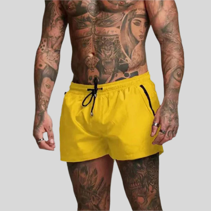 Versatile men's drawstring swim shorts with zip pocket. Ideal for swimming, beach, or casual wear.