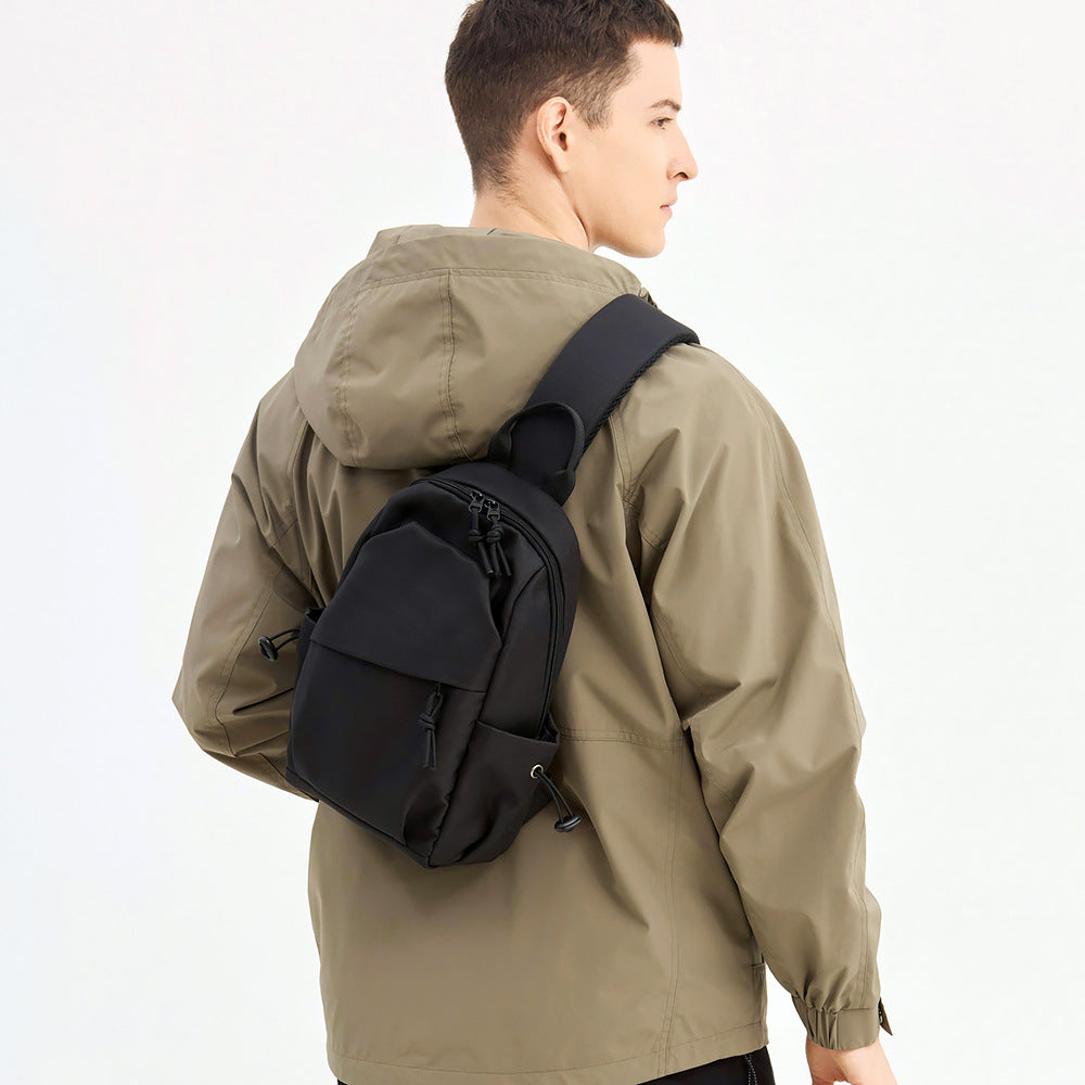 Men's durable sling backpack, perfect for urban adventure & travel. Black crossbody bag, everyday carry.