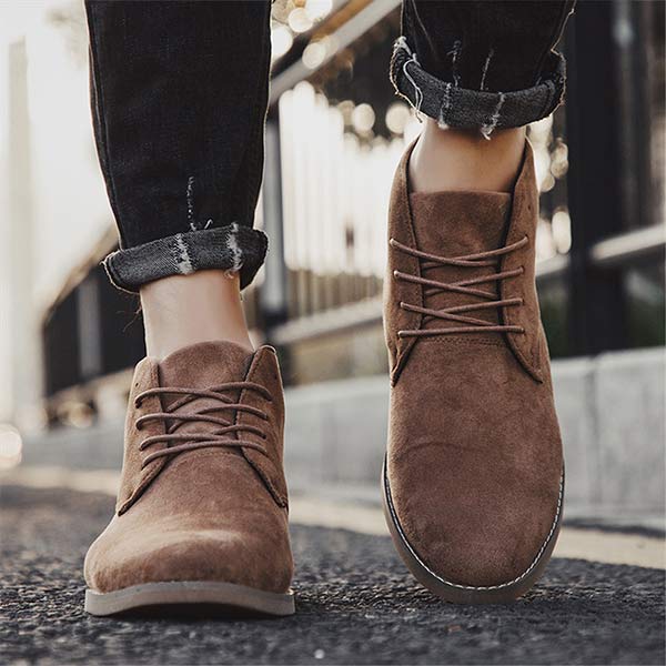 Pair of men's durable lace-up ankle boots, offering cushioned comfort & supportive footwear for casual fall/winter style.
