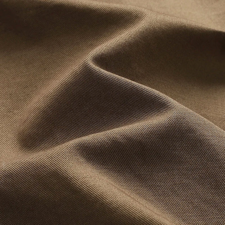 Modern men's knee-length cargo shorts, multi-pocket design for adventurers seeking comfort & utility.