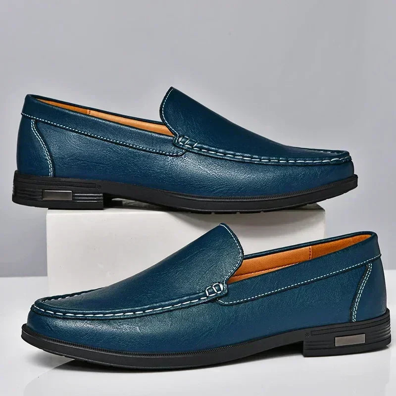 Detail of the durable sole and fine stitching on elegant men's black slip-on loafers. Sophisticated dress shoes for men.