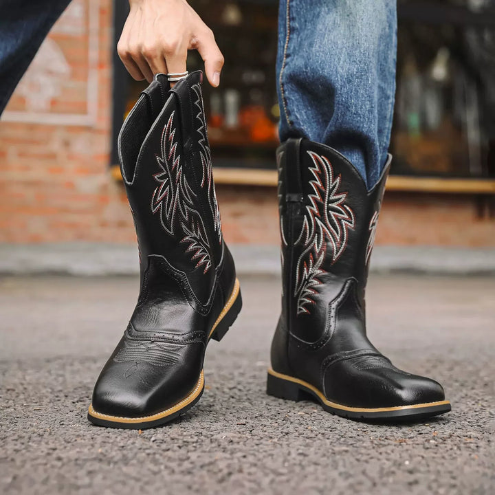 Structured men's mid-calf boots, dark leather, with subtle side embroidery, great for winter and autumn fashion.