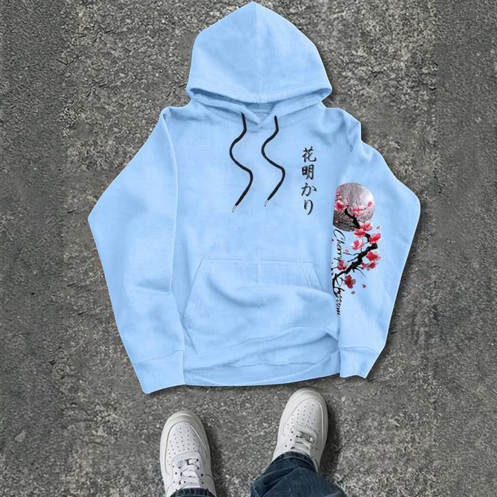 Man lounging in heather gray men's hoodie, emphasizing everyday comfort.