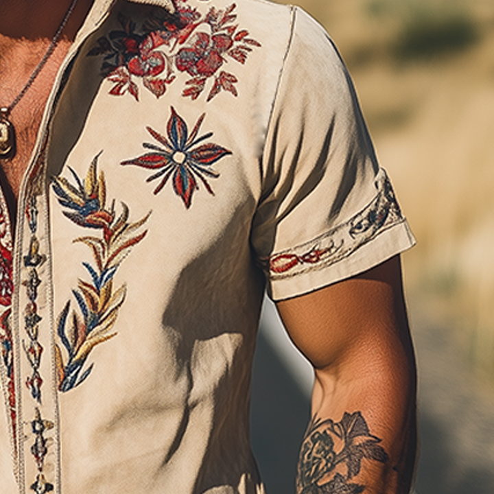 Fashionable man wearing a floral embroidered short sleeve casual shirt, ideal for a unique summer style.