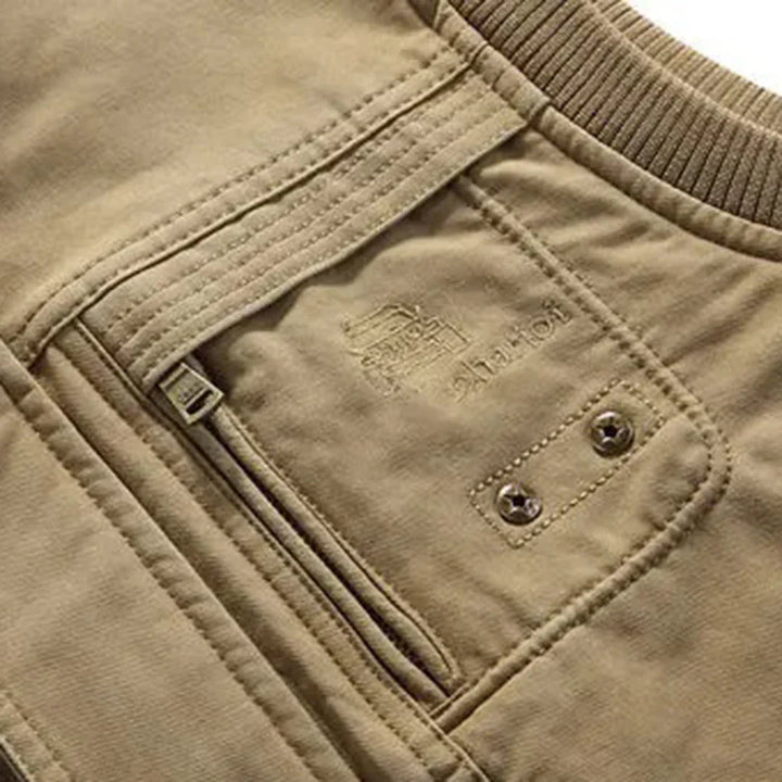 Rugged men's travel vest with multiple pockets, a versatile sleeveless jacket for fishing & hiking.