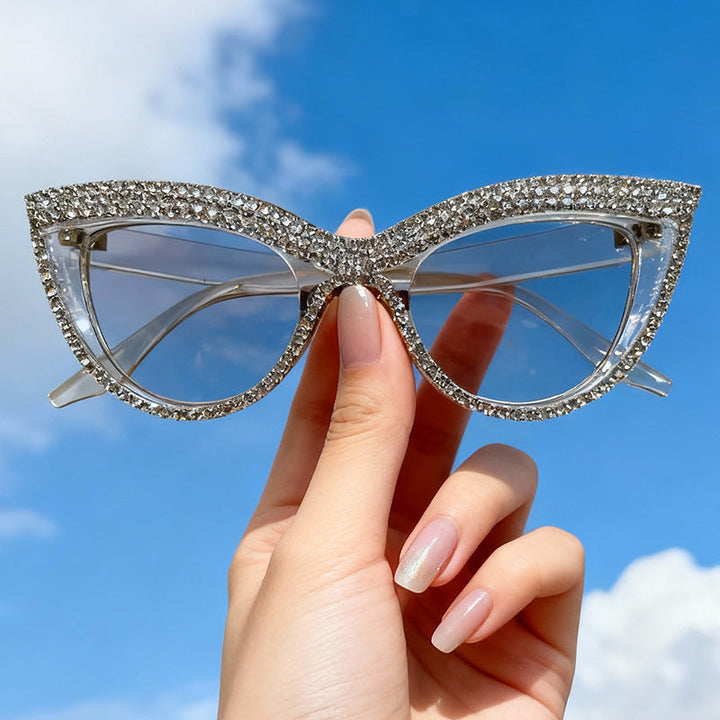 Stylish men's cat-eye sunglasses featuring rhinestone detail; UV protection for a glamorous fashion accessory.