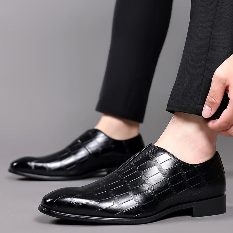Distinctive men's crocodile pattern slip-on brogues with a sleek glossy finish, modern fashion.