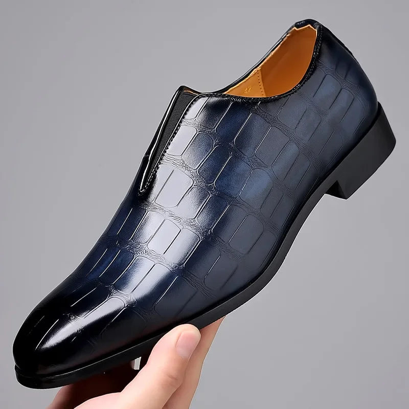 Elegant men's slip-on dress shoes, featuring a glossy crocodile texture and classic brogue details.