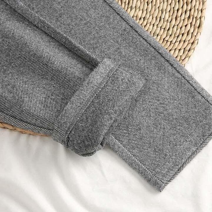 Stylish men's pleated herringbone pants. Comfortable and sophisticated for a modern look.