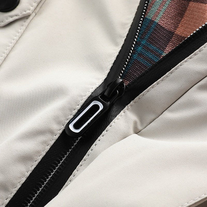 Rugged men's hooded utility jacket with many pockets, essential warm outerwear for winter cold.