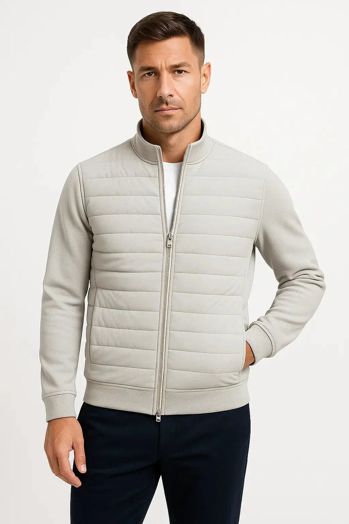 Unique men's hybrid jacket: quilted core for warmth, flexible knitted sleeves for comfort. A key transitional piece.