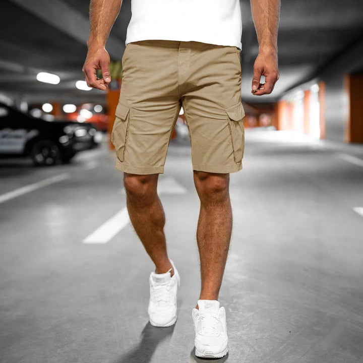 Durable men's cargo shorts, close-up of sturdy fabric, multiple utility pockets & quality stitching for active wear.