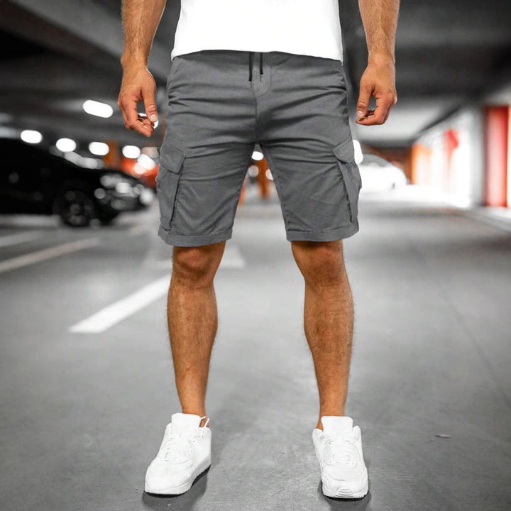 Back view of men's cargo shorts with flap pockets, emphasizing ample storage, comfortable fit & casual style.