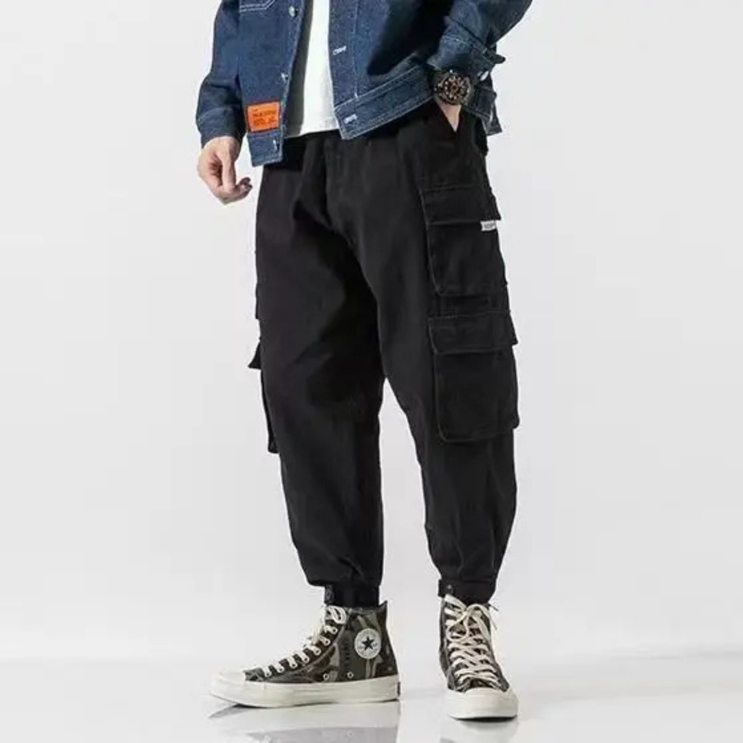 Green men's streetwear cargo pants with adjustable waist, combining style & practical utility.