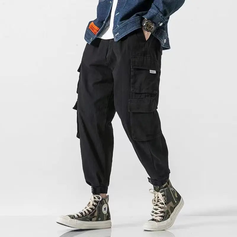 Khaki men's utility pants with a tapered fit, designed for comfortable, modern casual wear.