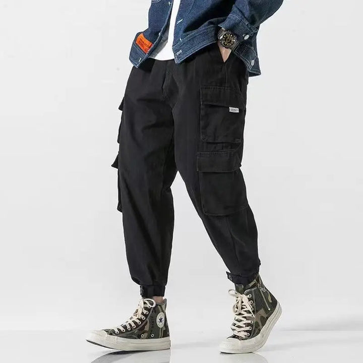 Khaki men's utility pants with a tapered fit, designed for comfortable, modern casual wear.