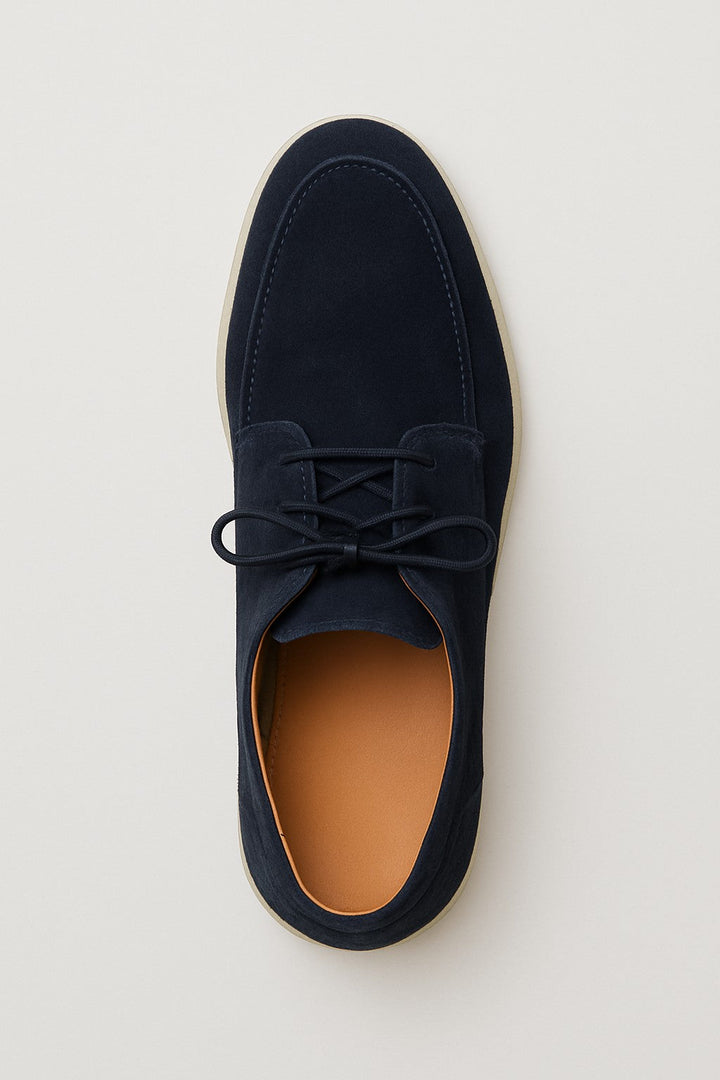 Comfortable men's lace-up moccasin loafers worn, ideal for versatile casual to smart casual autumn or spring fashion.