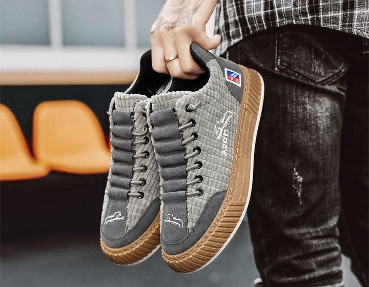 Modern men's low top sneakers, lace-up closure, unique quilted texture, comfortable for daily adventures.