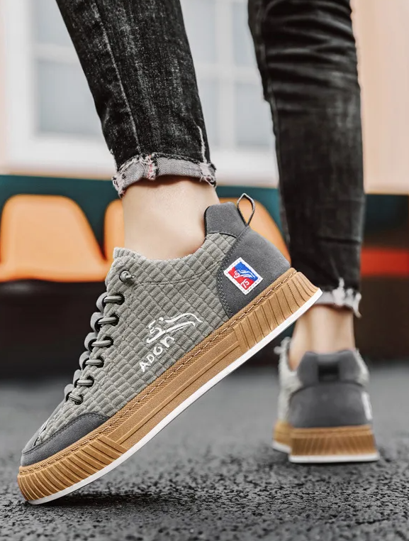 Stylish men's low top fashion sneakers with unique quilted design and practical lace-up closure.