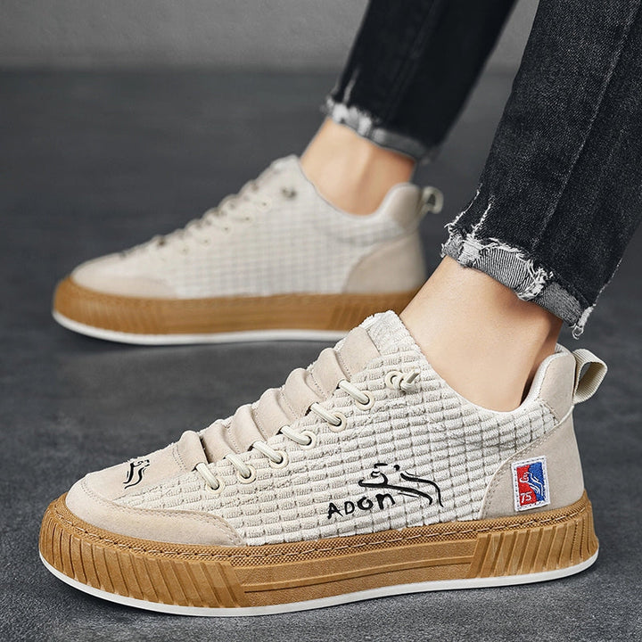 Everyday men's lace-up sneakers, quilted low top design, combining comfortable fit and stylish footwear.