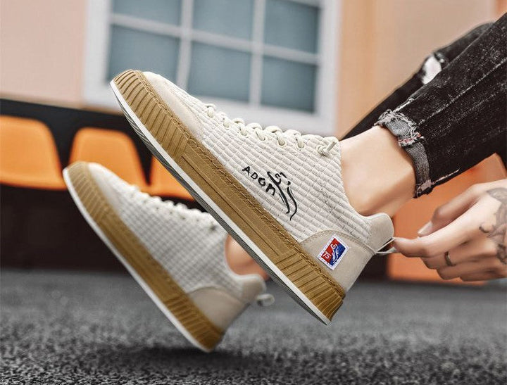 Stylish men's lace-up quilted low top sneakers with a non-slip sole, perfect for everyday fashion.