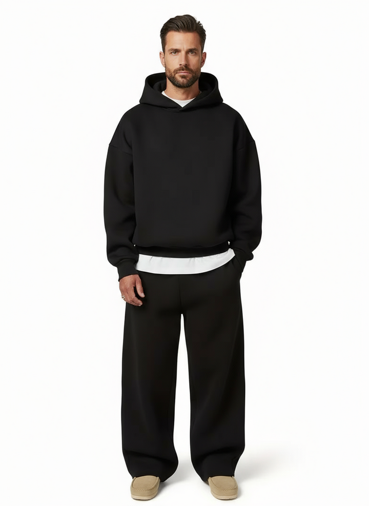 Black men's oversized jogger tracksuit for athletic casual wear & modern loungewear style.