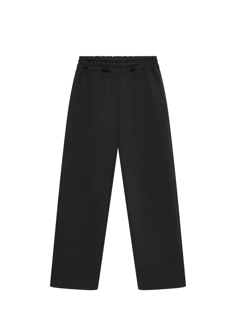 Man relaxing in a black oversized tracksuit set, showcasing ultimate comfort for casual loungewear.