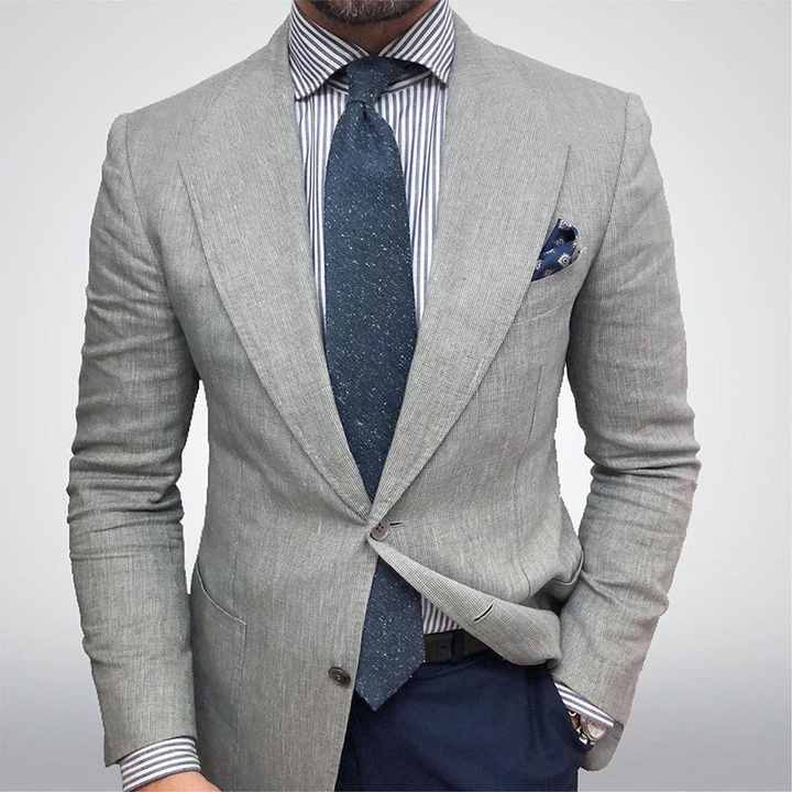 Stylish men's beige textured blazer jacket. A tailored fit for spring, suitable for formal business wear.
