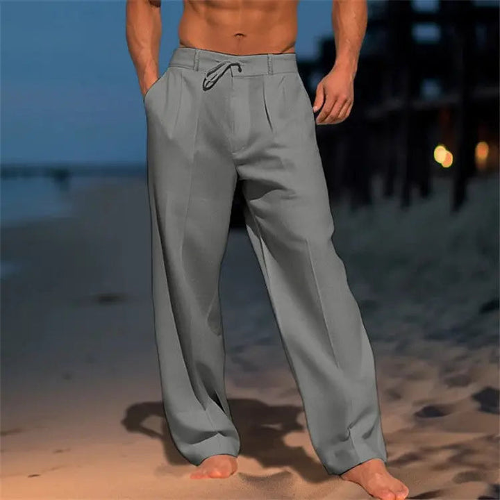 Stylish men's pleated front drawstring trousers with a relaxed fit, perfect for smart casual and summer wear.