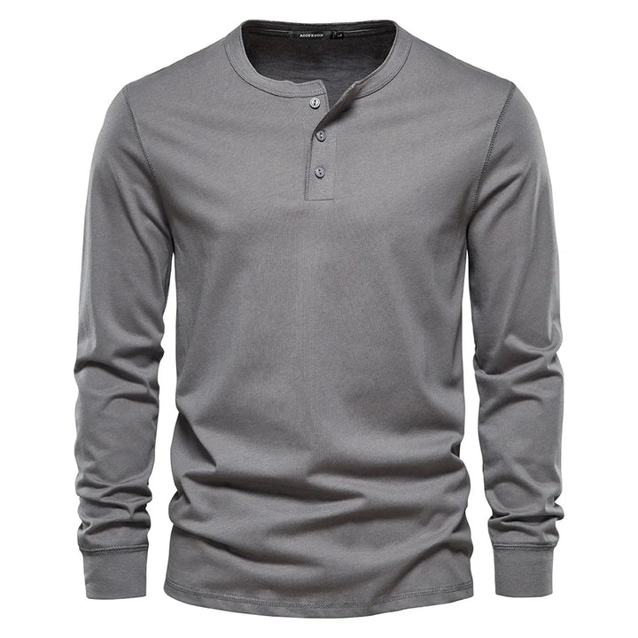 Classic men's long-sleeve henley shirt featuring a button placket & round neck for versatile style.