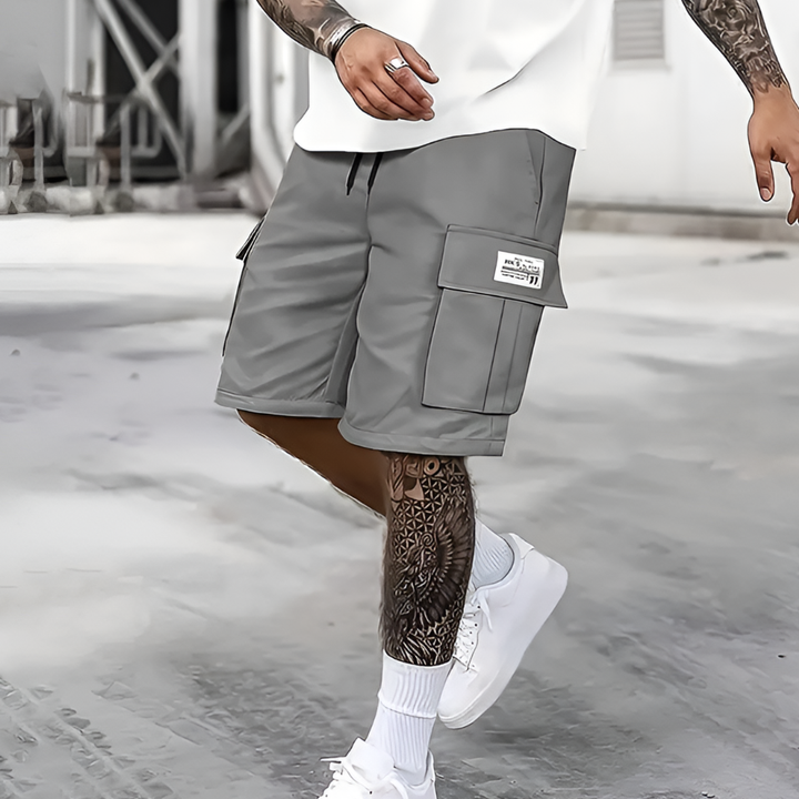 Men's loose fit cargo shorts for casual summer wear. Features elastic waist, drawstring & knee-length comfort.