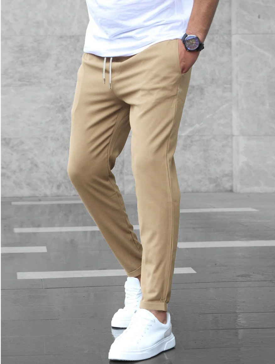 Man showcasing the flexible movement and comfort of luxury tailored stretch pants.