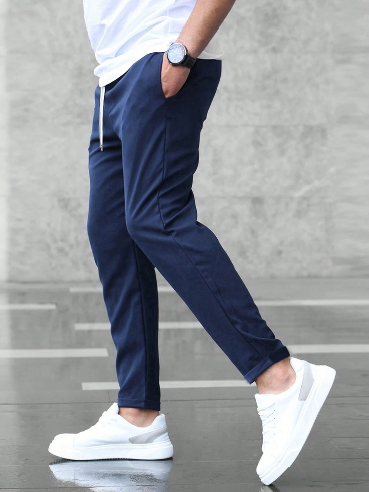 Luxurious men's stretch pants with a modern tailored cut, ideal for versatile styling options.