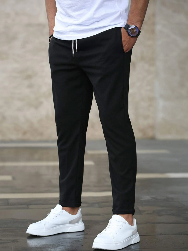 Close-up of premium fabric on men's luxury stretch pants, highlighting quality and stretch.