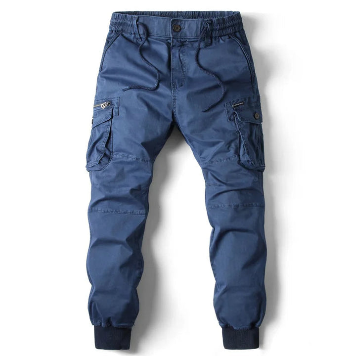 Tapered fit men's cargo joggers with multiple functional utility pockets, ideal for streetwear.