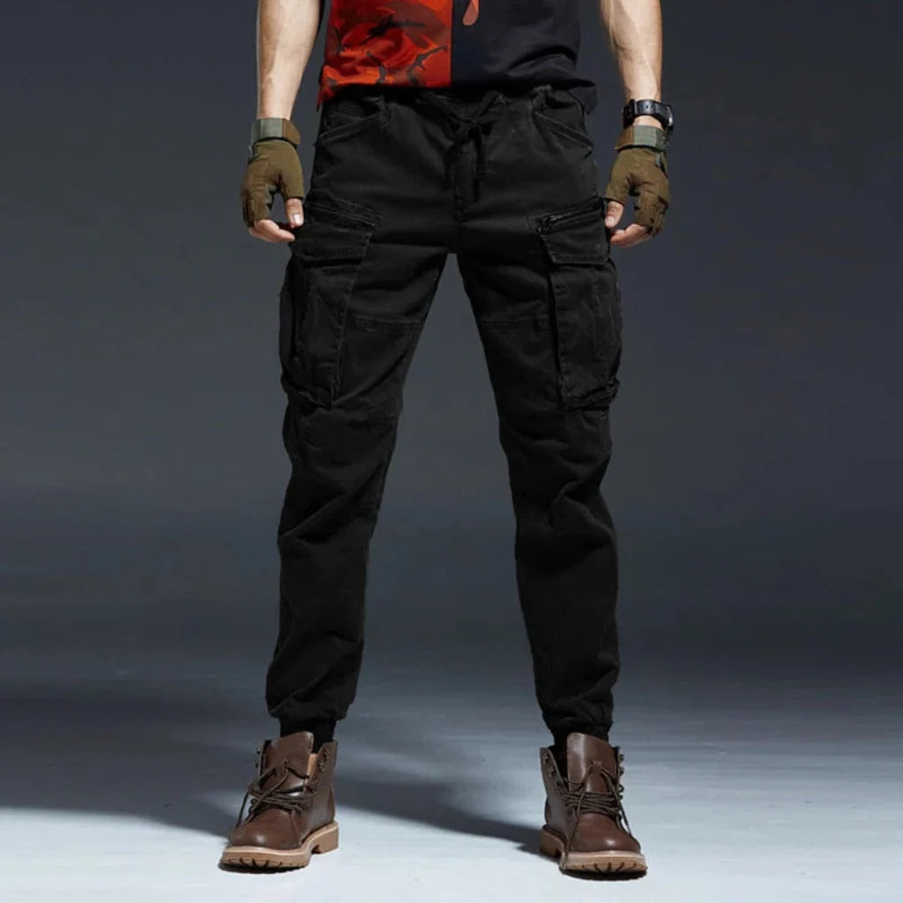 Man wearing comfortable, multi-pocket cargo pants, ideal for outdoor adventures, travel & casual style.