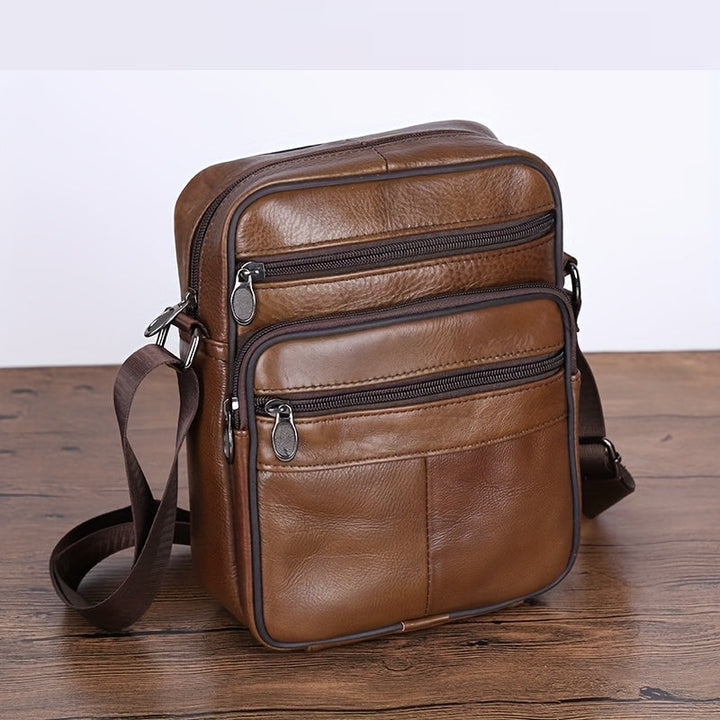 Brown textured men's travel bag, multi-pocket crossbody for secure and organized daily carry.