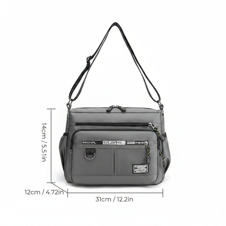 Modern men's multi-pocket crossbody messenger bag, sleek & waterproof for travel or daily use.
