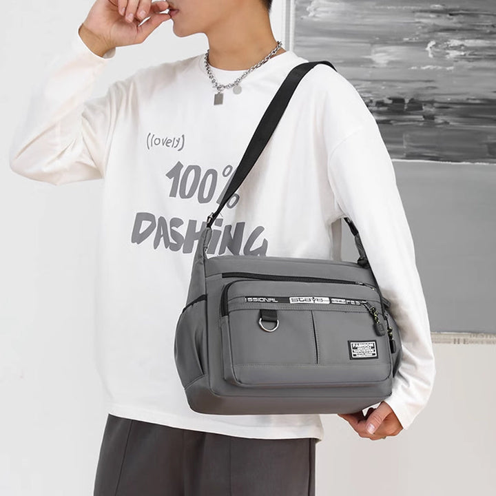 Multi-pocket men's crossbody messenger bag, ideal for organized daily carry & travel. Waterproof.