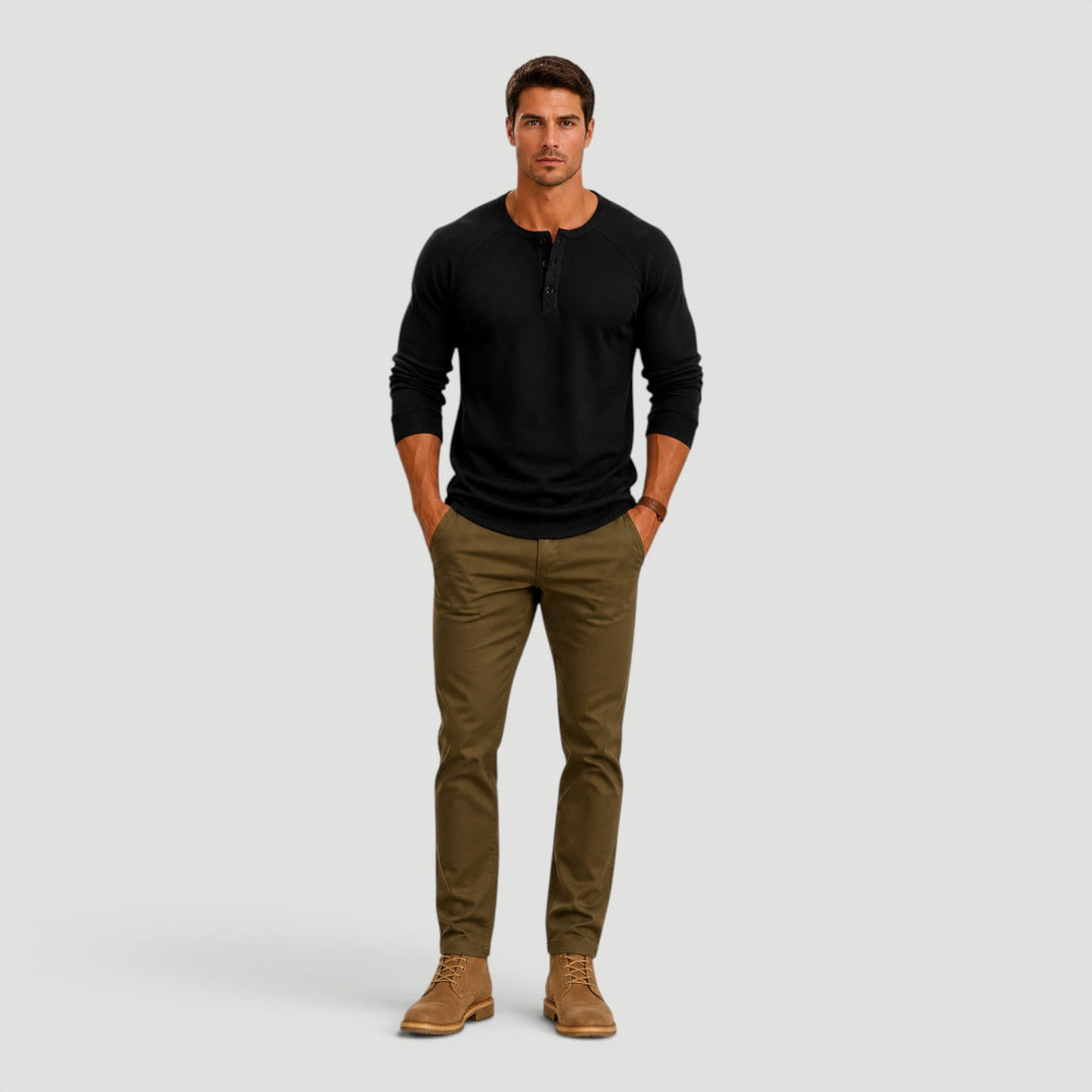 Stylish men's Henley sweater featuring a button neck and long sleeves. Refined, classic casual wear for modern men.
